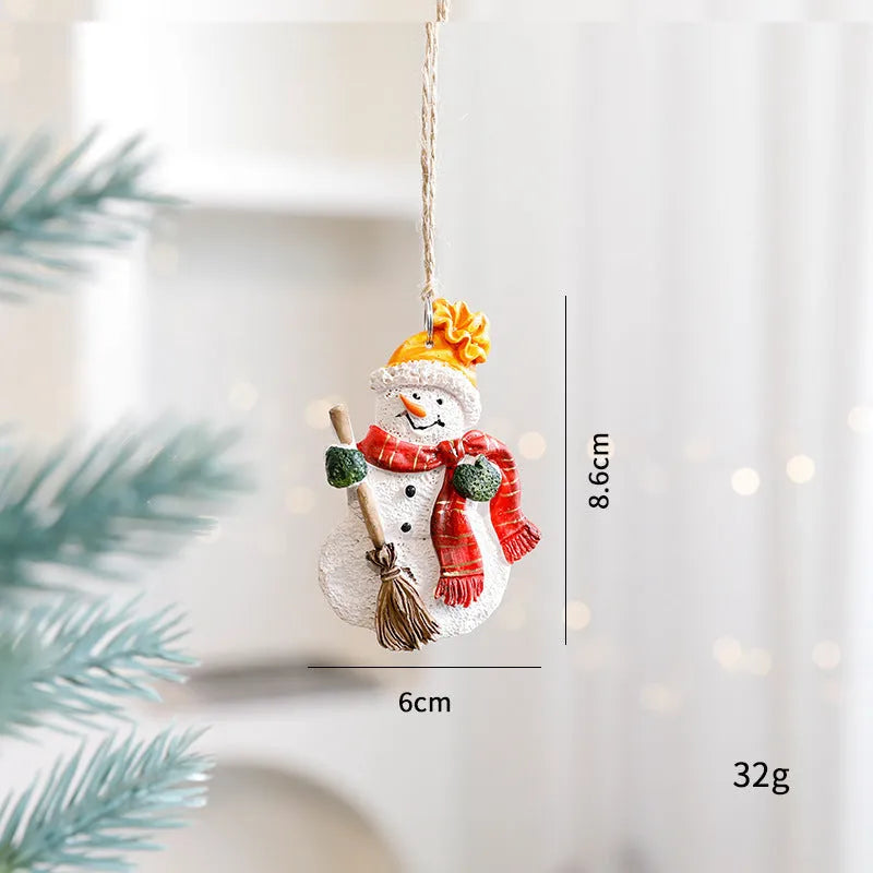 Small resin Christmas tree pendant ornament with a snowman figure holding a broom