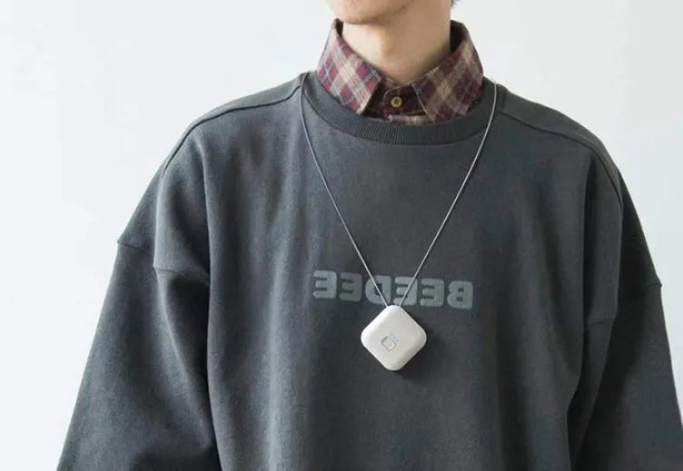 Mini USB rechargeable wearable air purifier necklace in pink, showing compact dimensions.