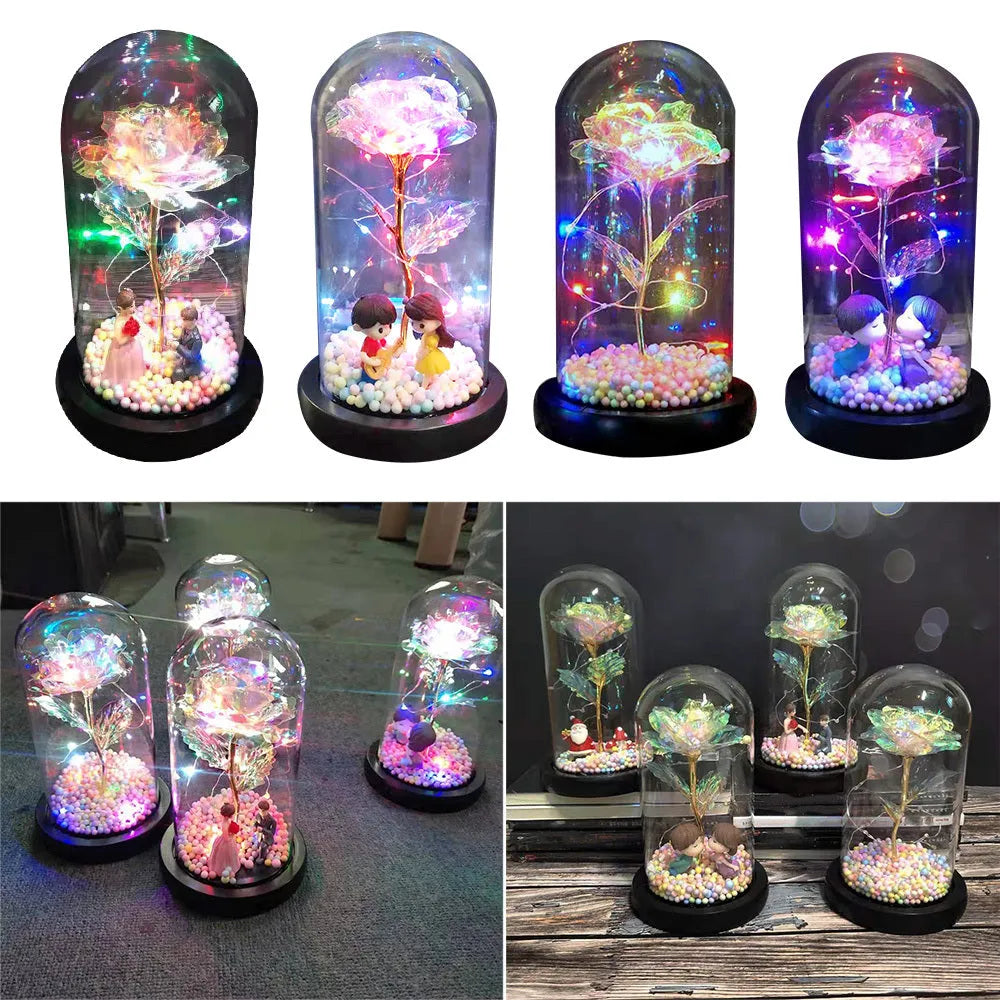 Artificial gold rose in glass flask with LED lights on black base, 20cm tall