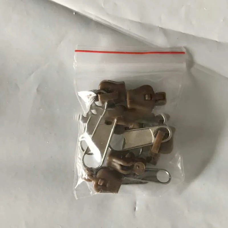 Plastic and metal zipper head replacement kit in brown, black and half black colour options, snap-on design
