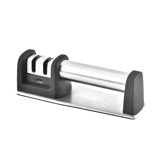 New kitchen sharpener made of black ABS plastic on a surface, manual knife sharpening tool