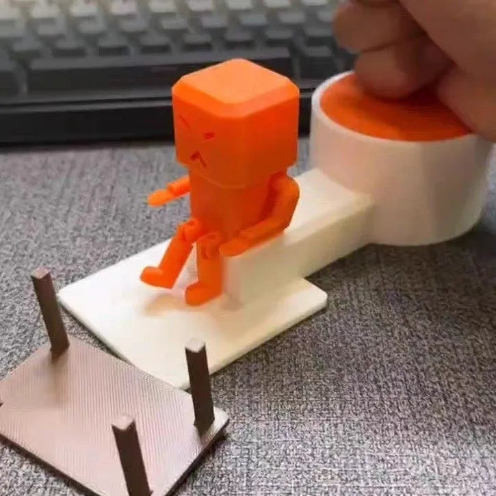 Orange plastic vent decompression toy on desk showing table turning mechanism