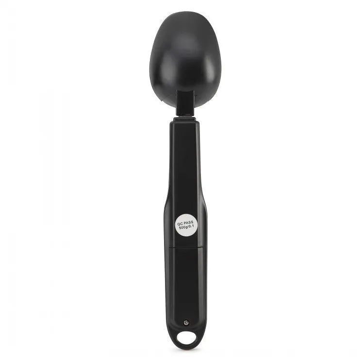 Digital smart measuring spoon with LCD display showing weight reading, on a kitchen countertop