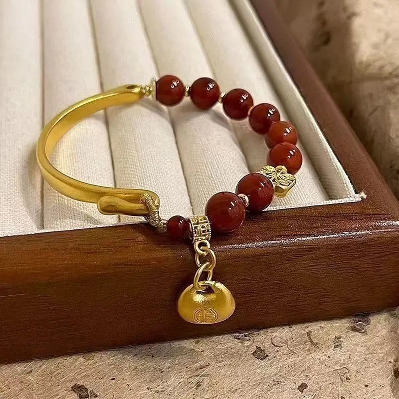Golden South Red Agate Character Ingot Bracelet with lucky bag charm on a white background