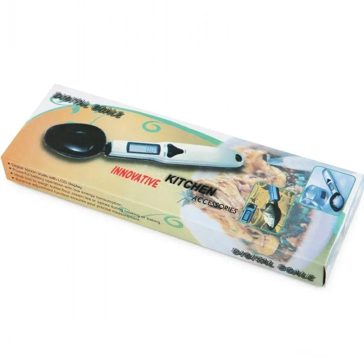 Digital smart measuring spoon with LCD display showing weight reading, on a kitchen countertop