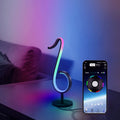 Black intelligent APP remote control LED atmosphere night light with 180 degree rotating chassis on a desk