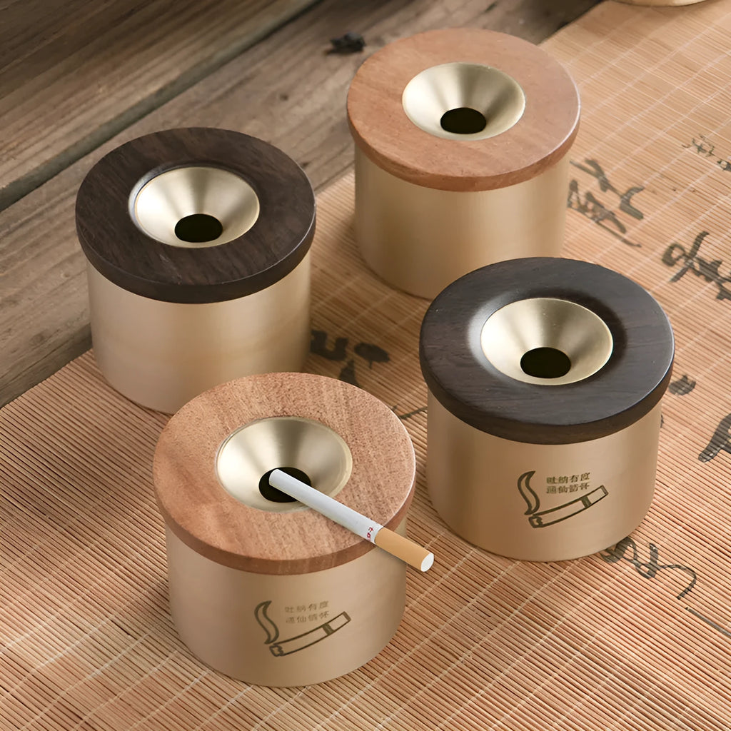 Brass ashtray with wooden lid showing central aperture design