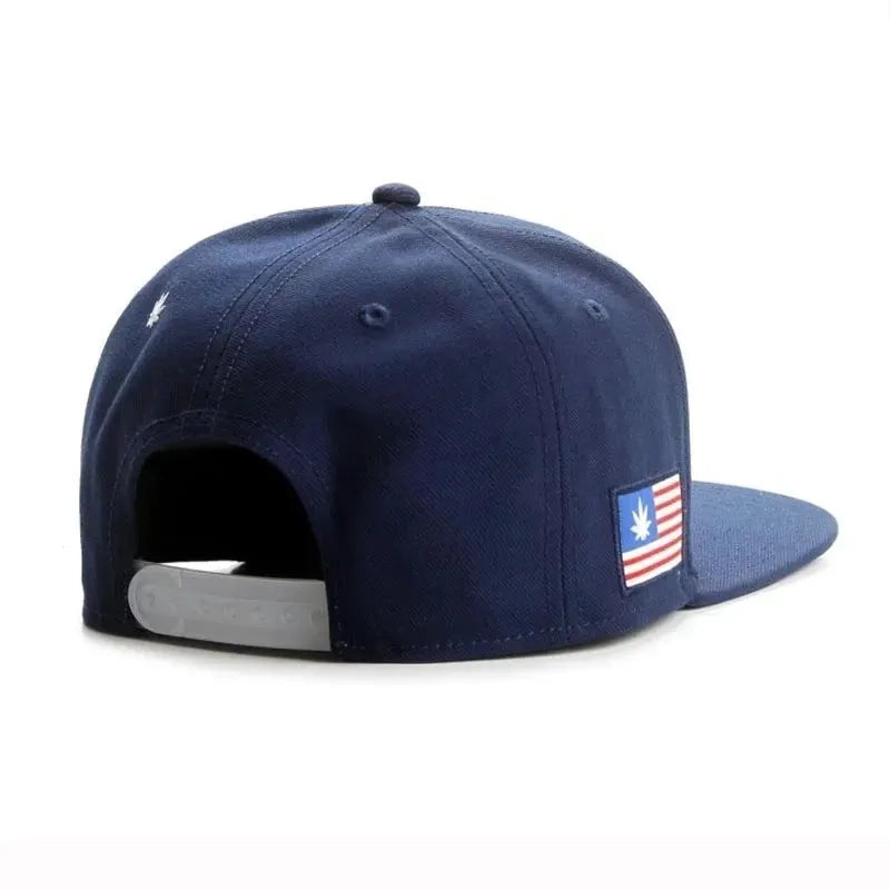 Navy blue cotton baseball cap with machine-embroidered English letters on front, dome crown, adjustable back strap