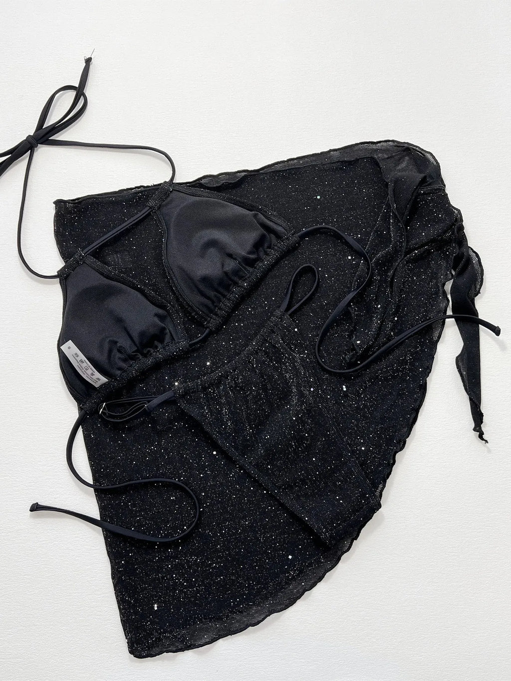 Black three-piece women's bikini swimsuit with separate top and shorts