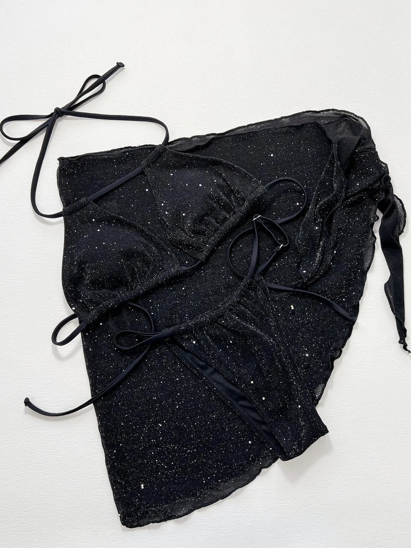 Black three-piece women's bikini swimsuit with separate top and shorts