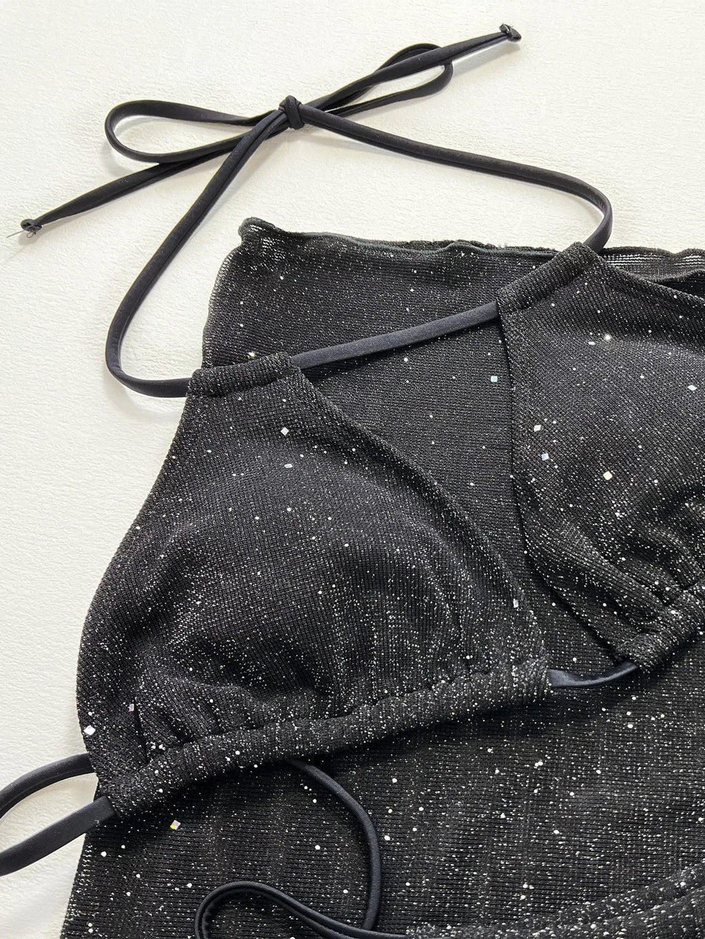 Black three-piece women's bikini swimsuit with separate top and shorts