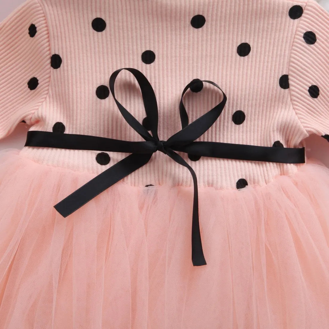 Baby girl wearing long sleeve lace tutu dress in pink for birthday party