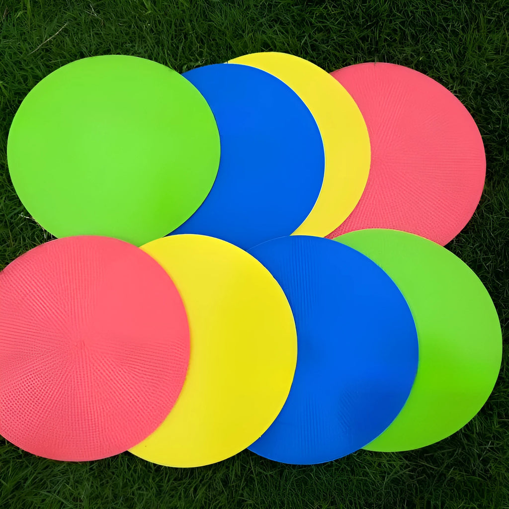Flat circular yellow football training landmark pad on grass, 23cm diameter