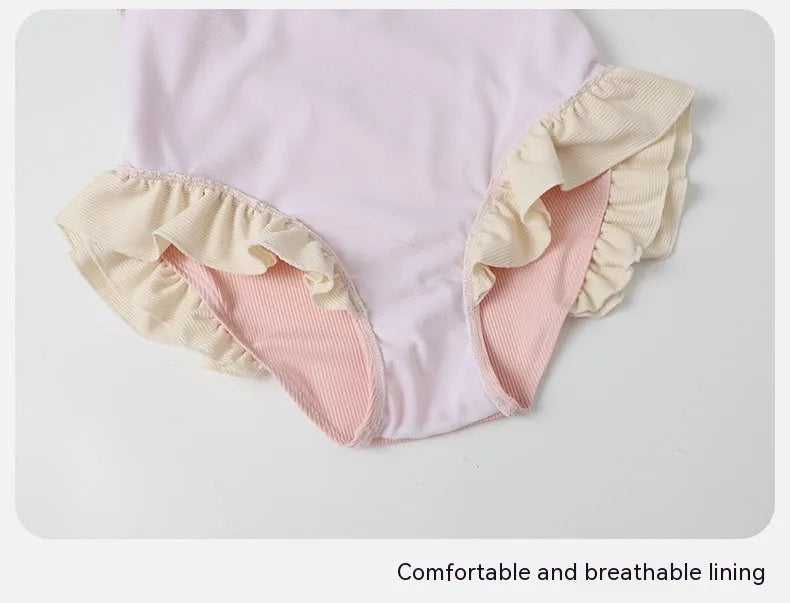 Pink women's conservative one-piece swimsuit with Siamese-style detailing on mannequin