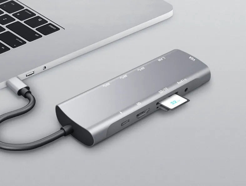 Grey aluminium USB-C docking station with HDMI, VGA, USB 3.0, and charging ports