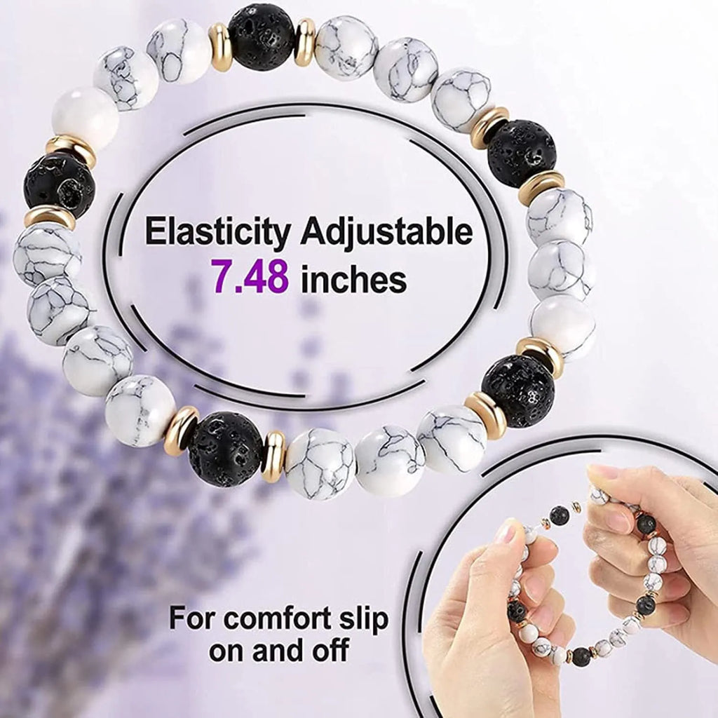 Handmade natural stone bracelet with alloy volcano and white turquoise beads on neutral background