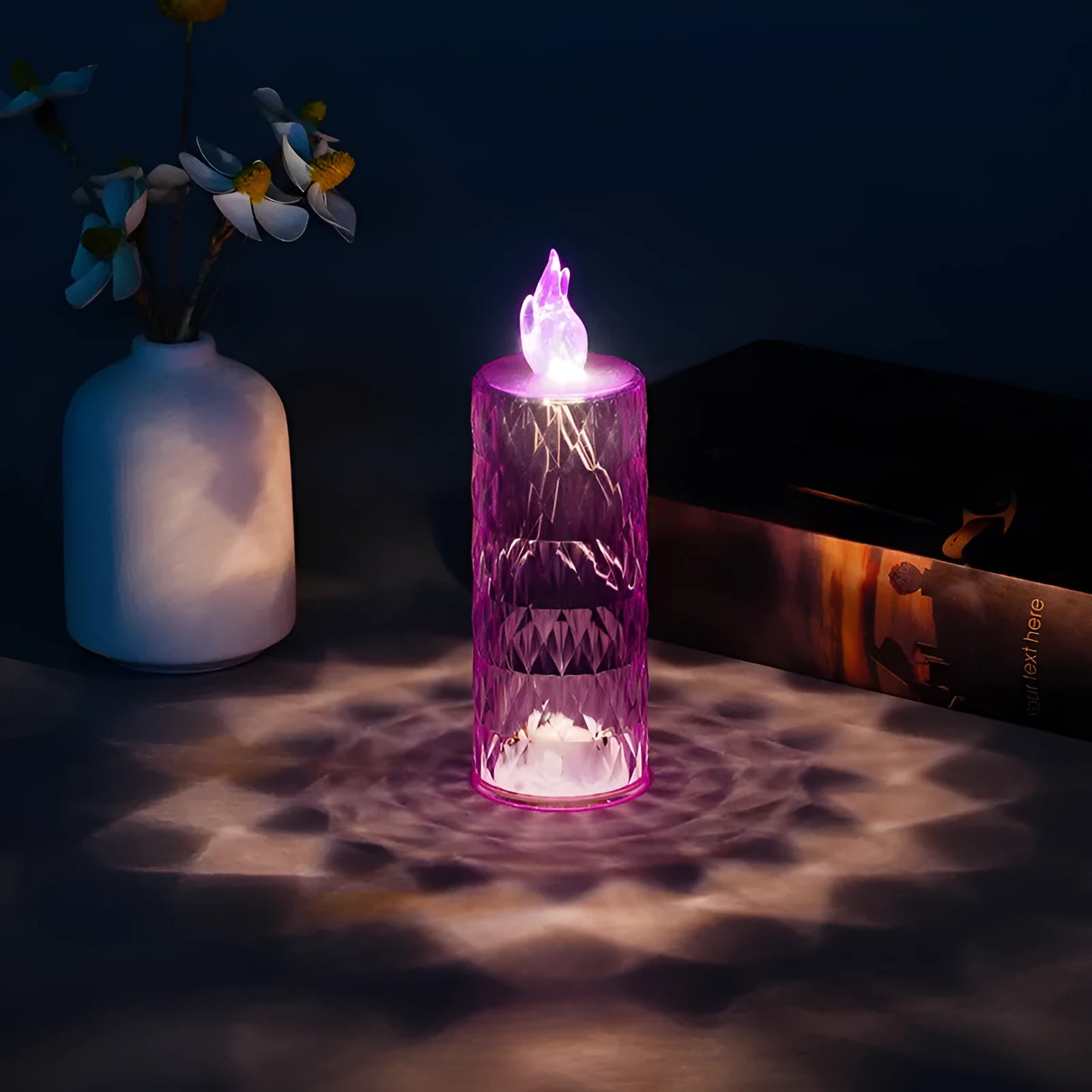 LED electronic candle lamp in ABS plastic with diamond style pattern, transparent colour, shown with base
