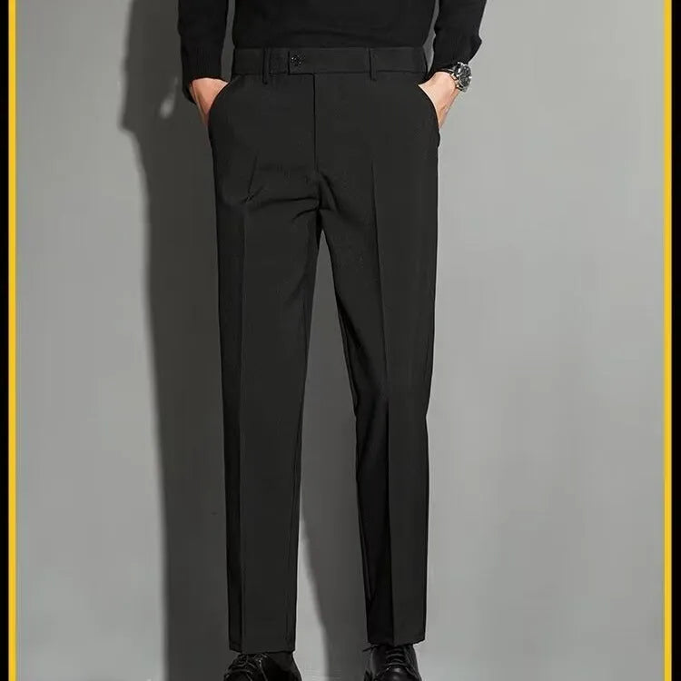 Men's straight-fit ankle-length suit trousers in a light gray colour, showing the draping effect.