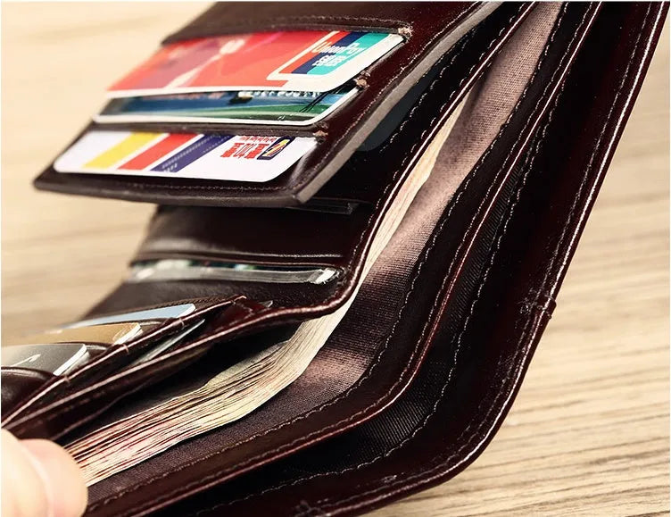 Men's black or brown leather wallet open to show photo window, card slots, and coin pocket.