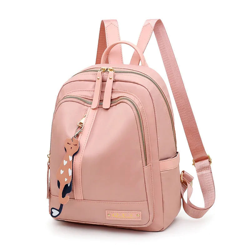 Women's black nylon casual backpack with double shoulder straps, soft handle, and front pocket.