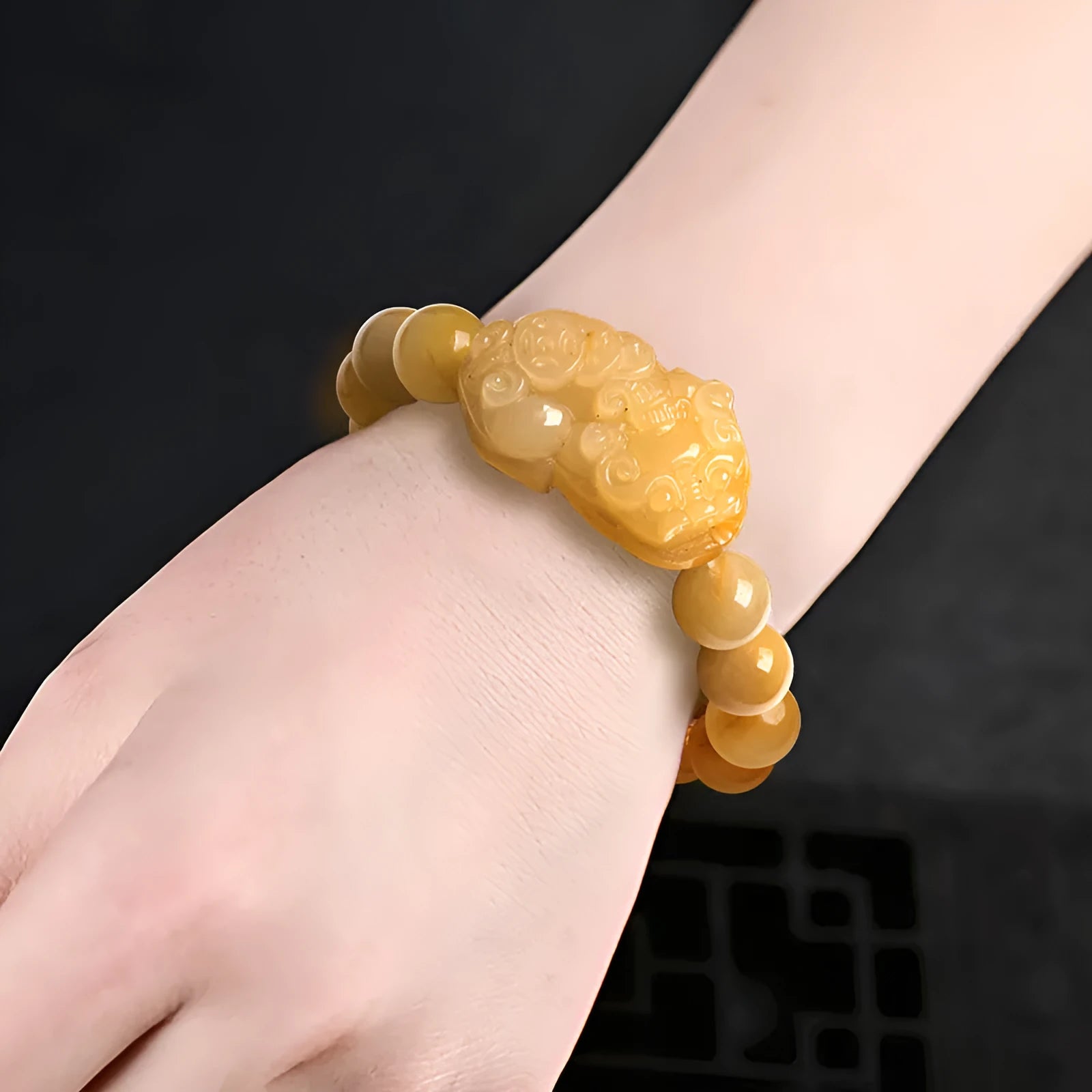 Carved golden thread jade money bracelet with traditional Chinese design showing detailed money motifs