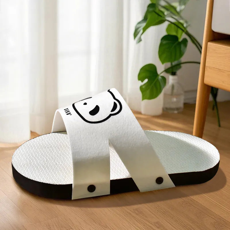 White corrugated cardboard cat scratch board shaped like a slipper on a plain background.