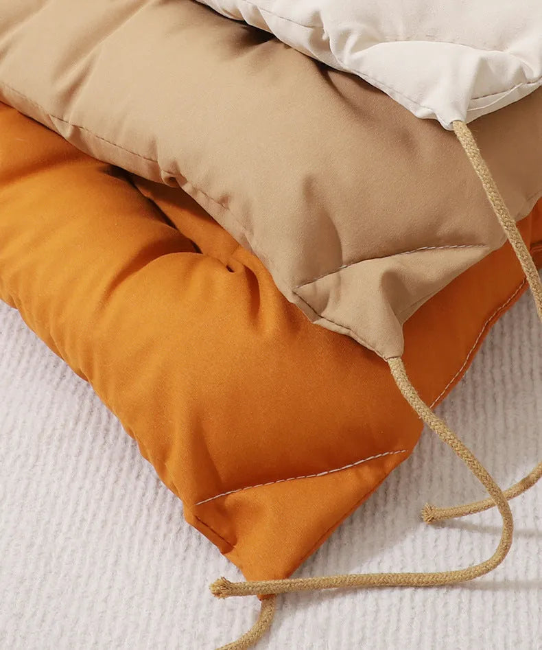 Tied cage cushion for dogs and cats in beige, showing platform attached to wire crate bars – size L.