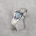Women's geometric ellipse ring in white gold tone with inlaid zircon detailing, showing contemporary design