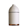 White ultrasonic aromatherapy diffuser with LED lights showing water mist emission