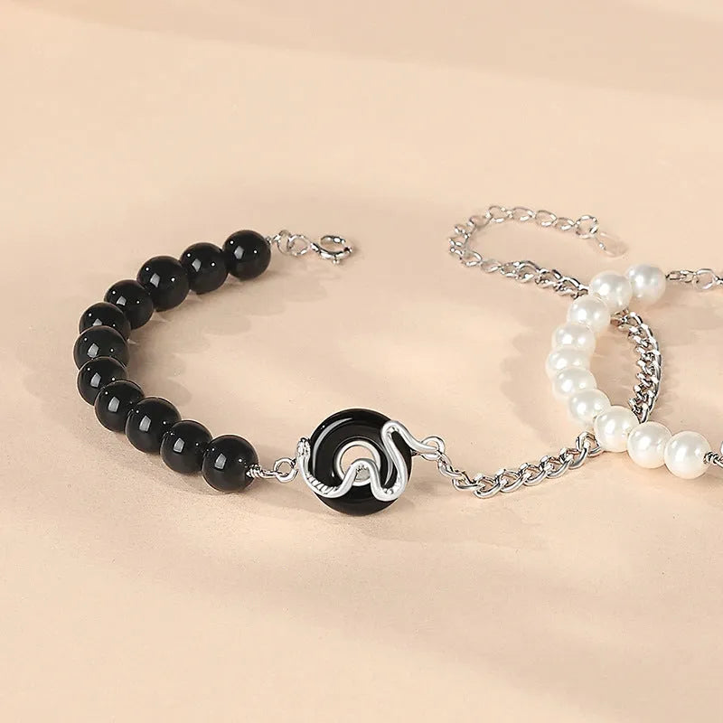 A New Chinese style 925 sterling silver couple bracelet with an obsidian pearl and snake zodiac motif on a secure buckle.