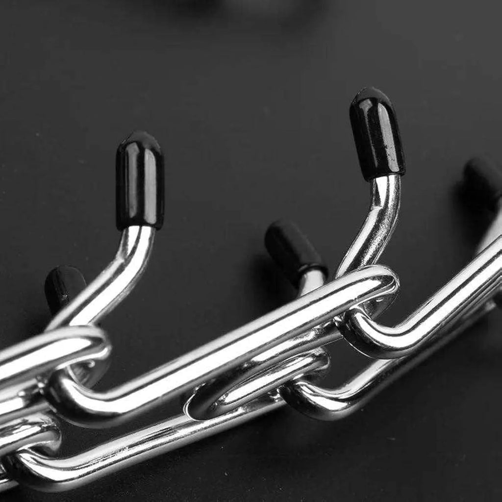 Stainless steel dog prong training collar with black comfort rubber tips on adjustable chain links.