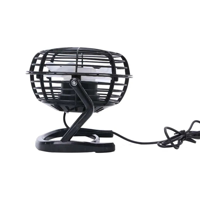 Small black USB desk fan with adjustable head on a wooden desk next to a laptop