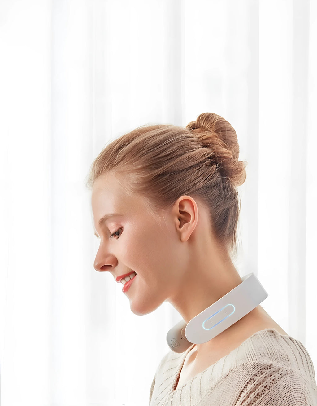 White electric acupressure massager device for neck, shoulder and back pain relief.