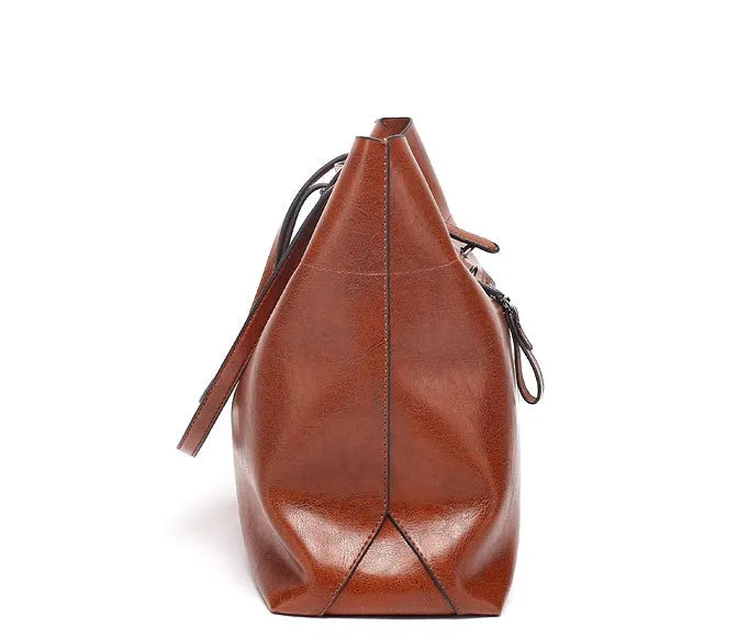 Brown waxed cowhide leather crossbody handbag shown horizontally, displaying two main compartments and a front phone pocket.
