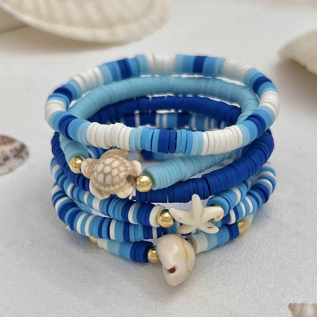 Set of six blue polymer clay handmade shell bracelets with geometric design, unisex bohemian style