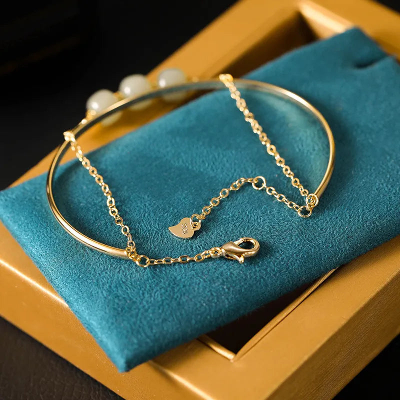 Women's Hetian jade lucky bead bracelet with gold inlay, showing single, double, and three bead version options.