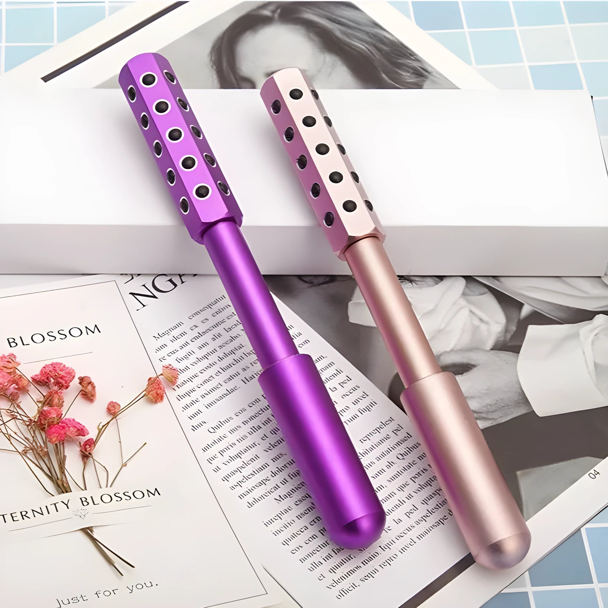 A handheld purple germanium particle facial massage roller on a white background.