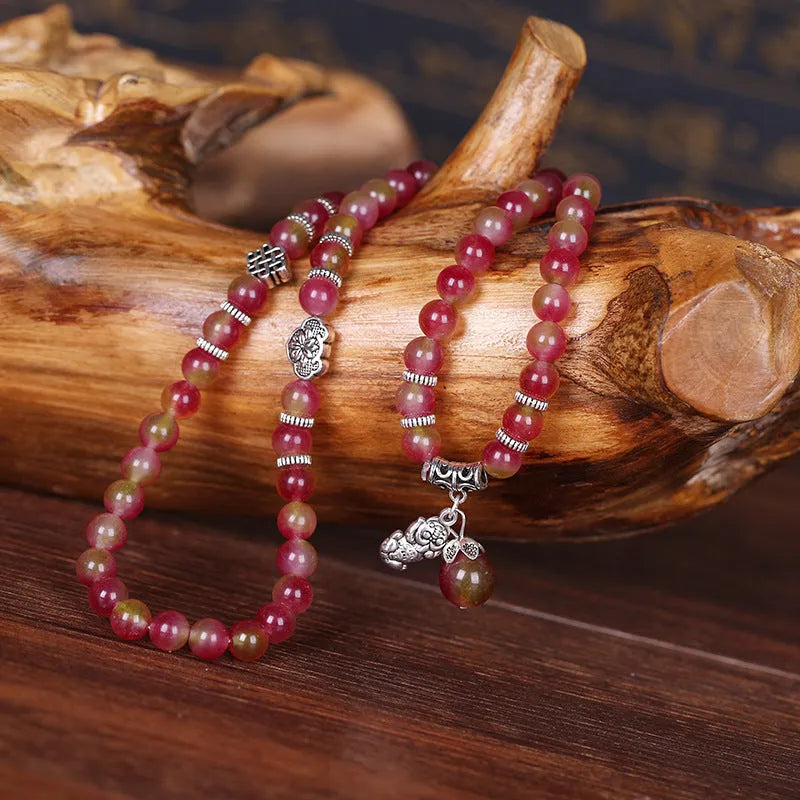 Handmade bracelet with geometric watermelon crystal beads and Chinese knotting in 6mm or 8mm size.