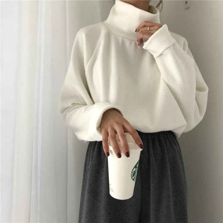 Women's loose-fit long sleeve top with a half-high collar in apricot colour.