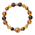 Natural tiger-eye crystal bracelet with geometric beads in either 10mm or 12mm size on a wrist.