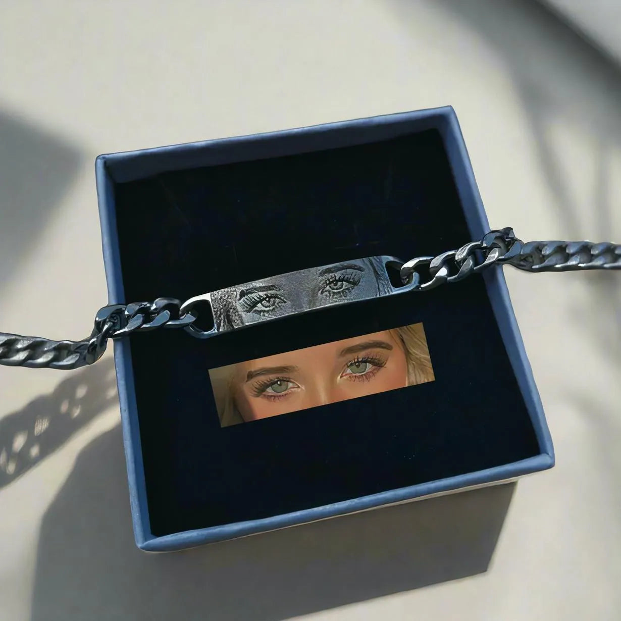 Personalised stainless steel bracelet with laser engraved human eye design, available in black, gold, and silver finishes