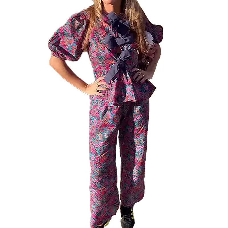 Women's floral printed trousers suit with tie-neck top featuring puff sleeves and matching trousers