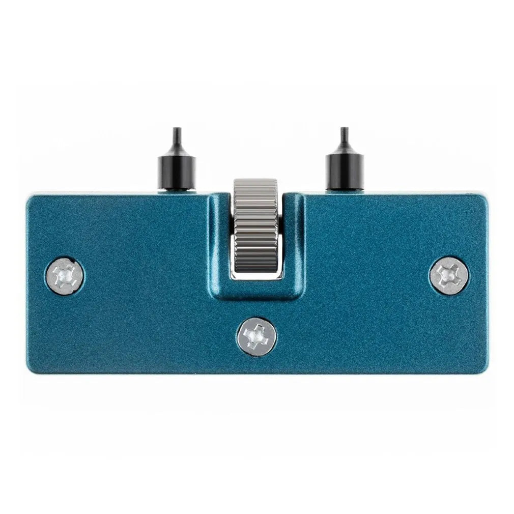 Yellow plastic watch repair case opener kit with mounting base and four fixing pillars on a workbench