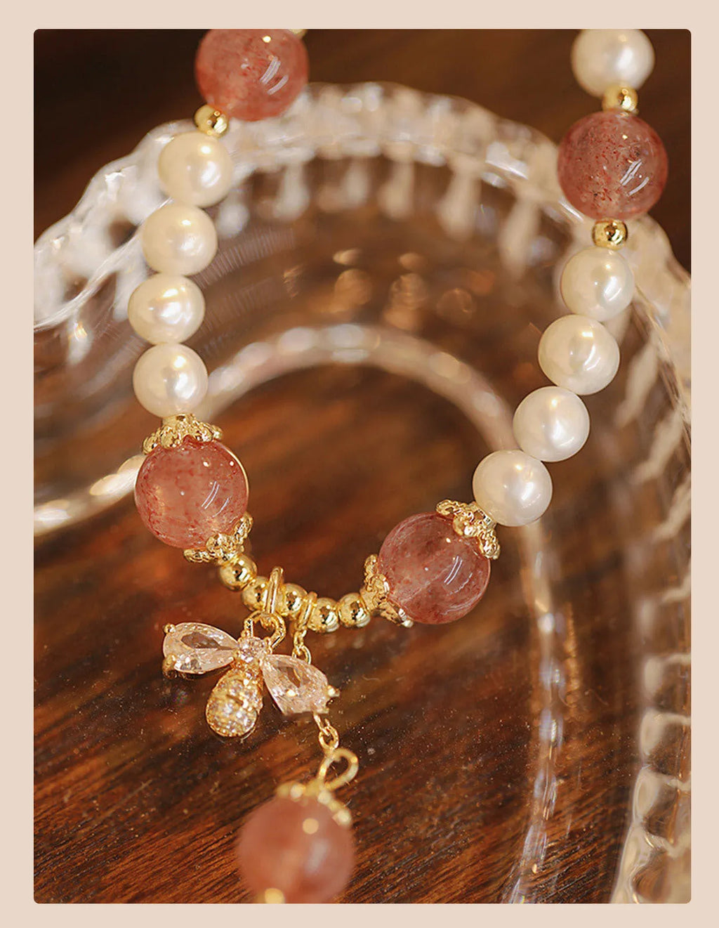 Close-up of a handmade crystal and strawberry quartz bracelet with a bow design, styled for women, INS aesthetic.