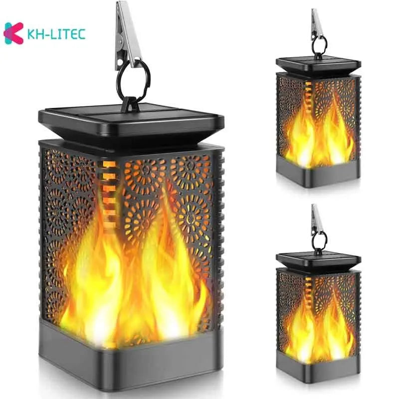 Set of four black solar flame torch lights with flickering LED effect for garden decoration