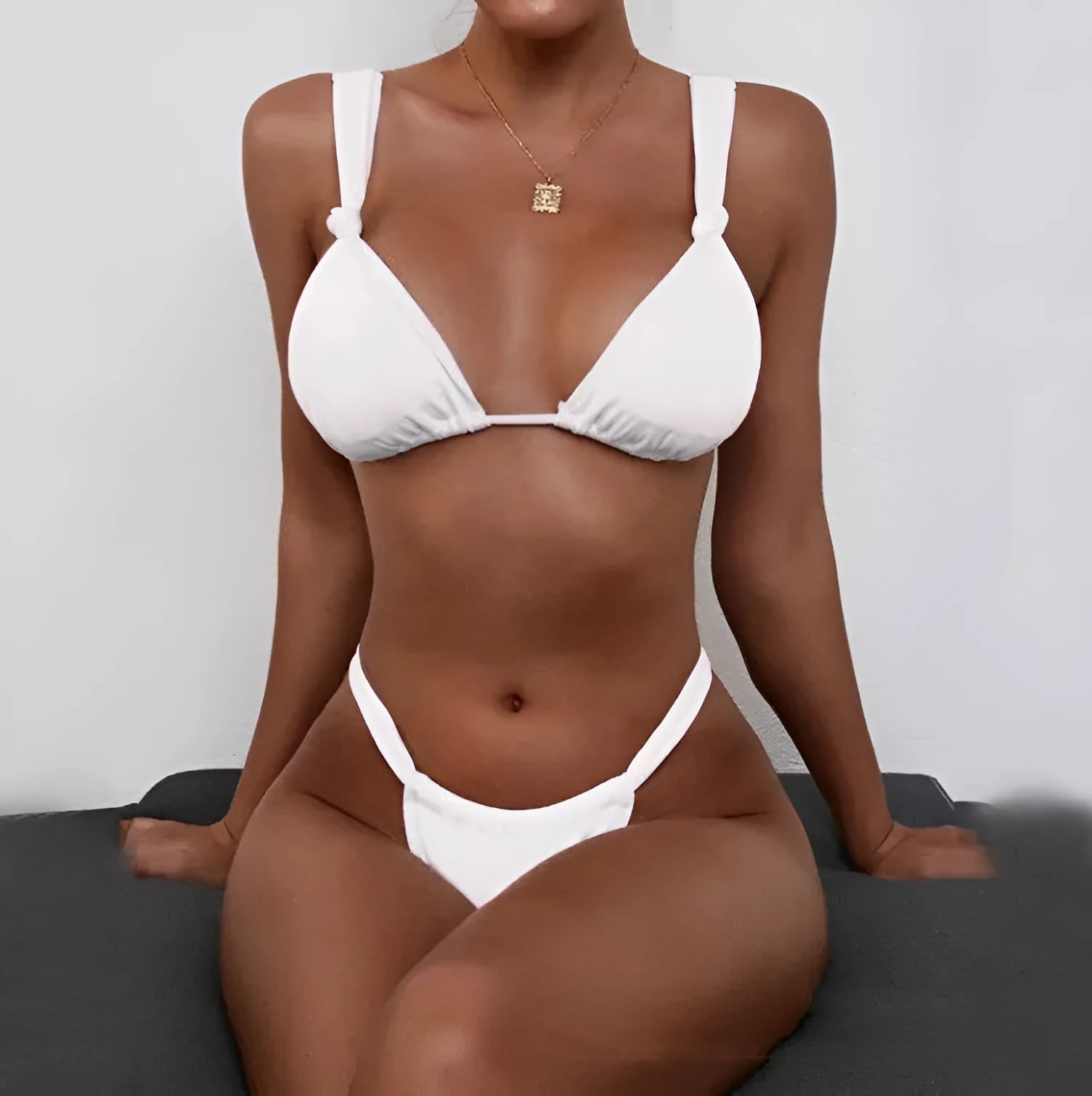 Women's pink bikini with pleated split straps tied in a knot, showing the briefs style.