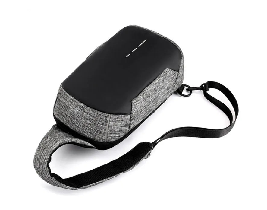 Small dark blue waterproof oxford cloth chest bag showing front zipper closure and strap