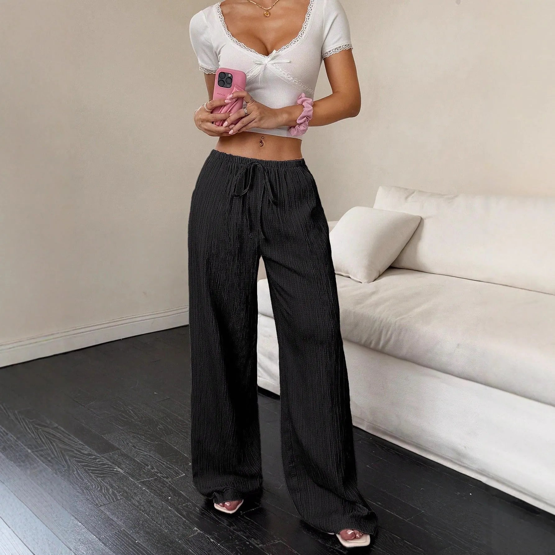 Women's black wide-leg trousers with lace-up waist trimming detail on mid waist