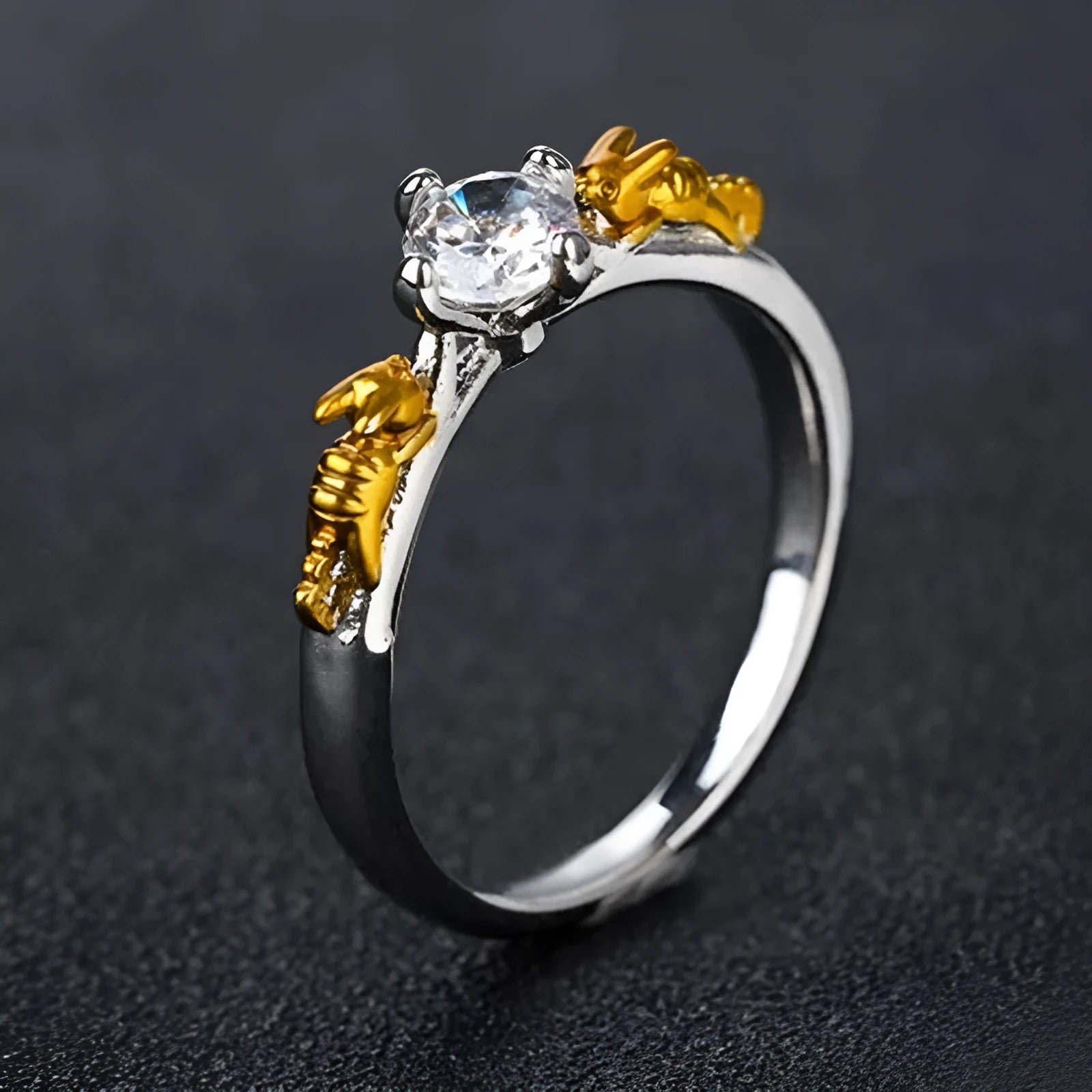 Copper crown ring with crystals in a black gold finish, shown on a finger.