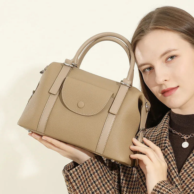 Genuine leather ladies handbag in black with contrast stitching and lock hardware